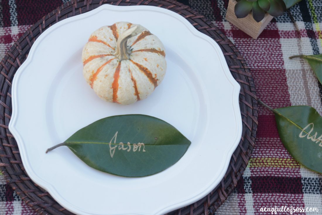 Thanksgiving Table Ideas with Leaf Place Cards. DIY Leaf Place Cards for Thanksgiving. These Magnolia leaves added the perfect touch. I think Joanna Gaines would approve - A Cup Full of Sass 